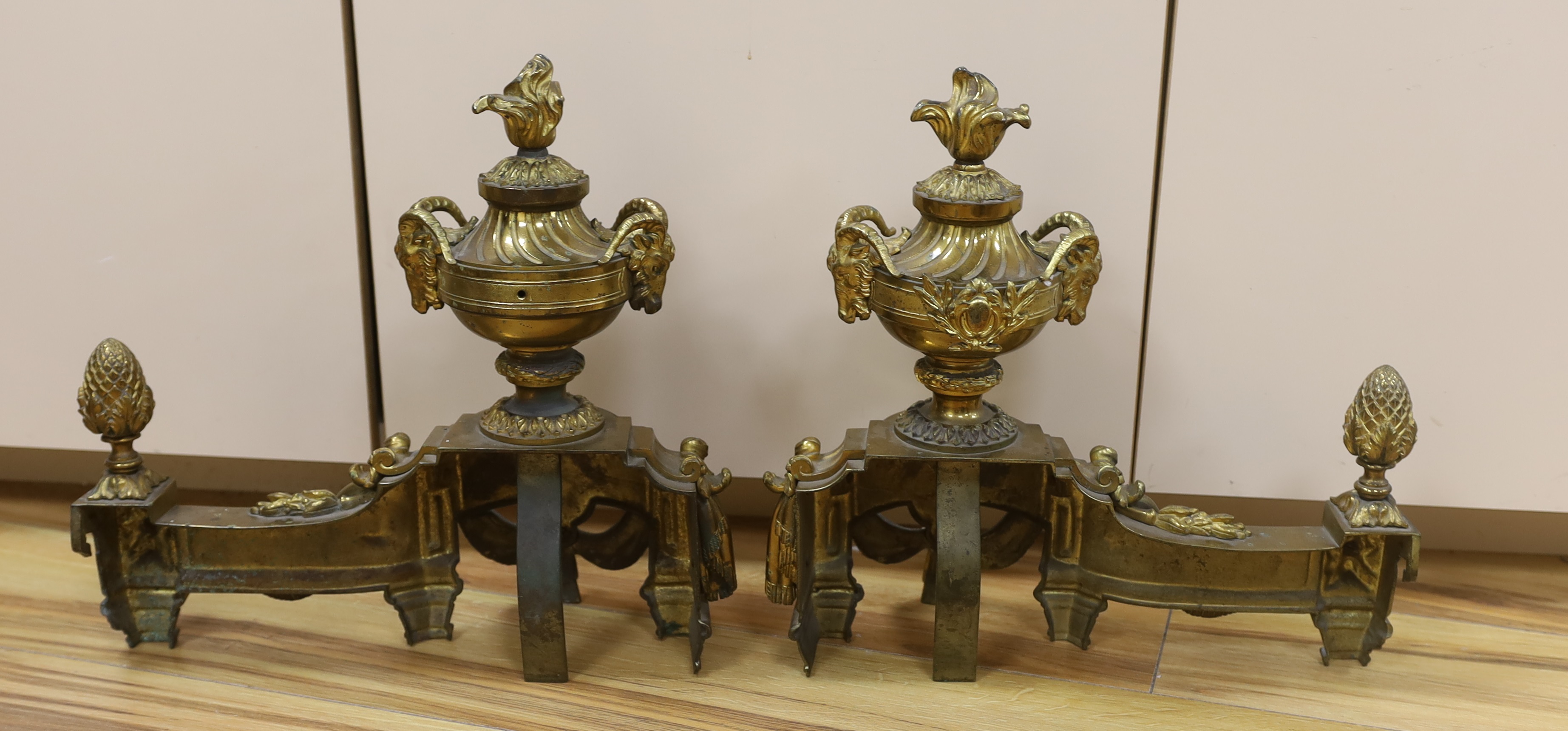 A French gilt bronze pair of urn shaped chenet, 39cm wide